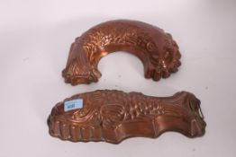 A pair of 20th century copper jelly moulds in the form of fish.