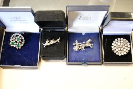 A collection of 4x silver and white metal ( 925 ) costume jewellery brooches,