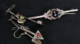 A vintage ladies silver brooch together with a pair of similar silver drop earrings,