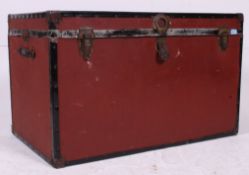 A 20th century burgandy steamer trunk chest with hinged top and brass clasp fittings
