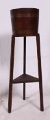 A 1930's Lister of Dursley oak coopered barrel planter raised on squared supports with original