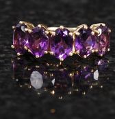 A 9ct gold five stone amethyst ring. 3.3g.