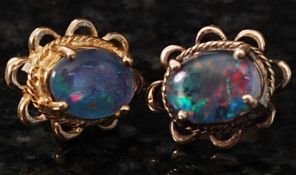A pair of black opal earrings mounted in 9ct gold studs. 2.