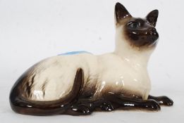 A Royal Doulton figurine of a siamese cat bearing Royal Doulton marks to the base,
