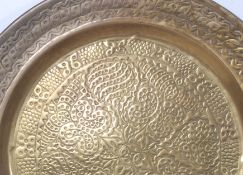 A vintage large 20th century Islamic brass hammered wall charger.