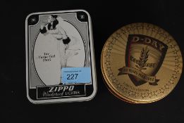 A still tinned unused D-Day limited edition Zippo lighter along with  a tinned Varga Girl 1935