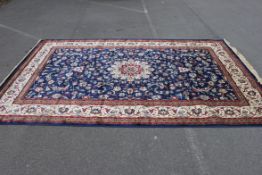 A brand new and unused large 3m x 2m Kashmir rug having a blue ground with central medallion and