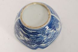 A 19th century Chinese blue and white bowl having willow pattern with scroll work details to the