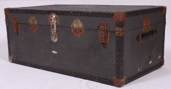A grey vintage 20th century steamer trunk with notation having hinged centre with clasps.
