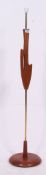 A 1970's retro Danish style teak and brass standard lamp raised on terraced base.