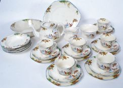 A good 20th century Midwinter tea service comprising teapot, cups, saucers, tea plates,