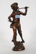 A 20th century bronze figure of flower seller, depicting a young man carrying flowers.