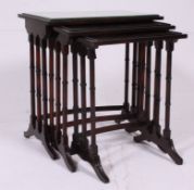 A good quality early 20th century mahogany nest of tables rising on faux bamboo supports united by