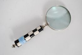 A large hand held magnifying glass with