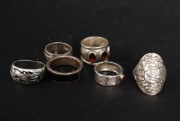 A collection of silver rings mostly cont