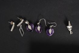 A collection of silver earrings to inclu