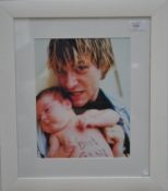 A framed photograph of Kurt Cobain with child.