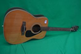 A six string acoustic guitar by Yamaha