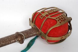 A 19th century officers cavalry sword complete with the metal scabbard having pierced decorative