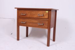 A 1930's solid oak art deco raised chest of drawers having flared top,