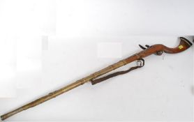 A 20th century large Jezail rifle of decorative form having brass mounts etc