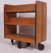 A retro 1960's oak library / school book trolley having sectional body in solid oak raised on