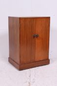 A mid 20th century pedestal record cabinet having central door with lined interior.