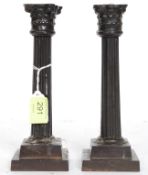 A pair of 19th century Victorian cast metal candlesticks in the neo-classical style with sconces