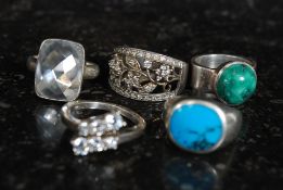 A selection of 5 silver dress rings some stamped 925 to include pierced and cabouchon set designs.