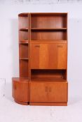A G-Plan teak wood sideboard display cabinet having sectional upright body with corner unit.