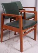 A pair of 20th century retro beech wood and faux leather covered school armchairs / chairs.