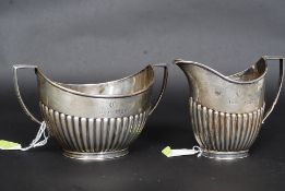 A silver hallmarked sugar bow and creamer by Goldsmiths & Silversmiths Company 112 Regent Street