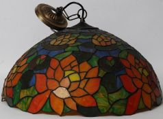 A large 20th century coloured glass Tiffany shade of circular form having decorative design.