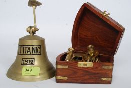 A vintage wall hanging reproduction brass bell with  Titanic notation along with a 20th century