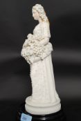 An impressive and highly detailed 20th century continental bisque porcelain figurine of a bride.