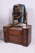 A 1930's Jacobean revival oak dressing table chest of drawers.