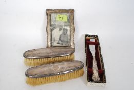A collection of silver items to include knives in presentation case, Clothes brushes,