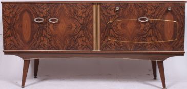 A retro 1960's faux wood melamine sideboar having drawers and cupboards being raised on angled