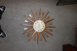 A retro 1970's vintage teak wood sunburst wall clock by Manley.  diameter is 61cms .