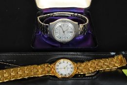 A vintage Timex Quartz gentlemans wristwatch having silvered dial with baton numerals and date and