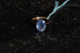 A Ladies 9ct gold ring set with oval cut sapphire. Weight 1.7g.