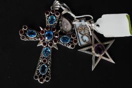 A selection of 4 silver pendants to include large crucifix style pendent encrusted with turqoise