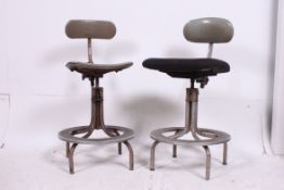An amazing pair of 1950's machinists industrial stools / chairs having oversized metal foot plates