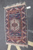 An early 20th century Persian handmade rug with cream ground having central medallion with