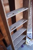 A large early 20th century wooden step gymnasium school ladder of tall form with pierced handles