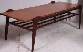 A 1970's teak wood suspension set coffee table of rectangular form having magazine rack to lower