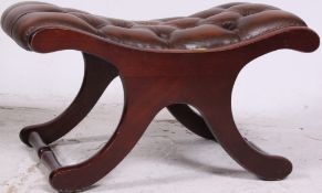 An antique style leather button backed Chesterfield style mahogany footstool.
