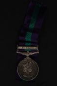 An Elizabeth II General Service Medal - Malaya Bar being issued to 4197814  S.A.C.