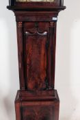 A 19th century flame mahogany grandfather clock with painted face and 8 day movement,