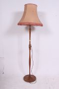 A good 1930's Art Deco walnut standard lamp having turned tall column and shade over a terraced